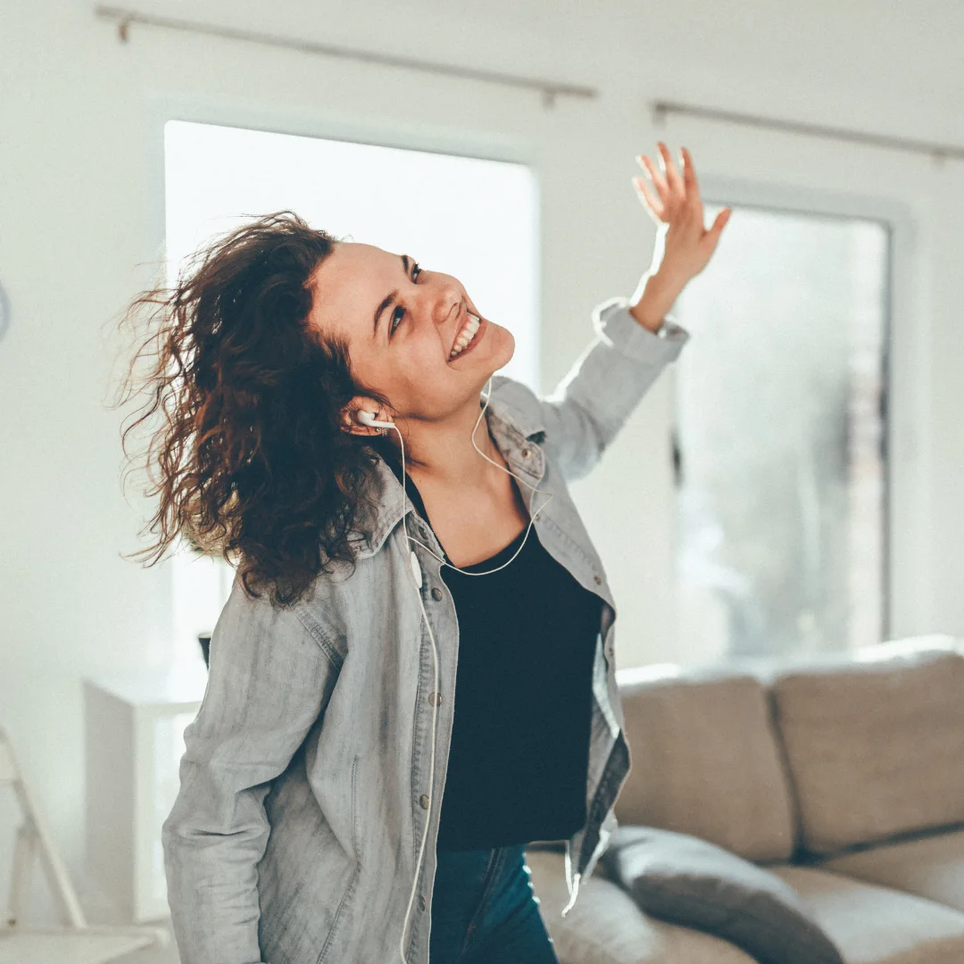 A woman dancing freely in her living room